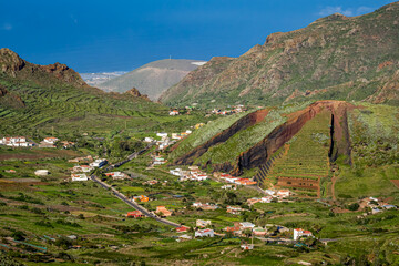 Fototapeta na wymiar The Palmar Mountain, a small volcano and former Lapilli quarry, with panoramic views over Palmar Valley to Buenavista del Norte with fertile landscapes and natural beauty in Tenerife's Teno mountains.
