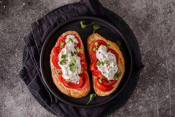 bruschetta with tomatoes and strachatella cheese