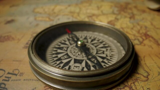 Old vintage retro compass on ancient map. Macro shooting