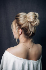 High beam. Photo of a stylish hairstyle on a girl's head from behind. Image for your creative...