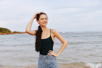 Fototapeta na wymiar woman summer lifestyle sea ocean sunset sand beach girl vacation smile