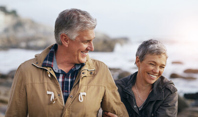 Senior couple, laugh and beach walk outdoor with smile from marriage and love. Happy, elderly...