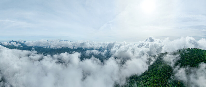 Aerial view Panorama of flowing fog waves on mountain tropical rainforest,Bird eye view image over the clouds Amazing nature background with clouds and mountain peaks in Thailand