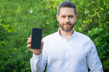 businessman showing app. businessman showing app outdoor. businessman showing app