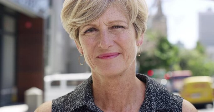 Face, smile and a mature woman in the city for weekend, happiness and vacation in Portugal. Happy, portrait and a smiling person in an urban town for relaxation, retirement holiday or enjoyment