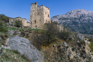 Fototapeta na wymiar Ruins of an ancient city high in the mountains. Medieval towers built of stone to protect against attacks. A fortress for protection. The city of Egikal in Ingushetia. Battle towers with loopholes.