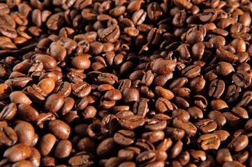 Coffee beans background. Texture of coffee beans close up. Dark brown roasted coffee is spinning. Abundance. Concept for coffee product advertising. Selective Focus. Border design with copy space 4K
