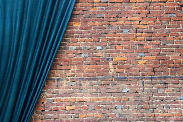 Old red brick wall with a green curtain.