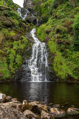 Fototapeta na wymiar The beautiful Assaranca waterfall plunging into a small pond, near Maghera, County Donegal, Ireland