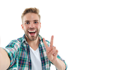 photo of millennial selfie man wearing checkered shirt showing piece. millennial selfie man