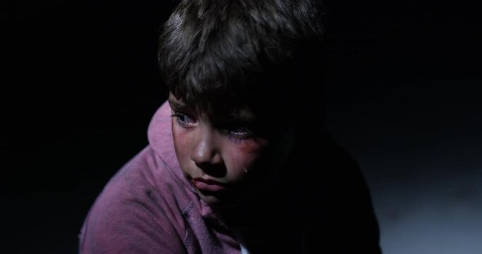 Child abuse, depression and violence with a boy alone in a dark room feeling sad as a victim. Portrait, children and anxiety with a young male kid looking scared or lonely and in need of help