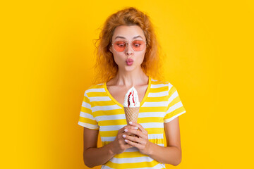 photo of girl with cone icecream at summer. girl with cone icecream isolated on yellow.