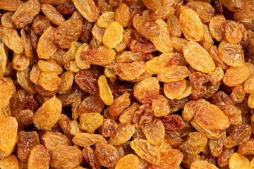 Raisins. Sun-dried yellow grapes closeup food background. Top view. texture. copy space banner