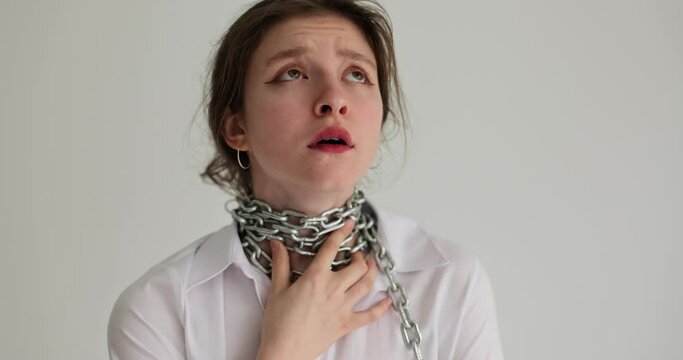 Portrait of woman touches chain around neck. Heaviness and sore throat or choking