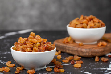 Raisins. Sun-dried grapes in ceramic bowl. superfood. Vegetarian food concept. healthy snacks. close up
