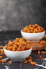 Raisins. Sun-dried grapes in ceramic bowl. superfood. Vegetarian food concept. healthy snacks. close up