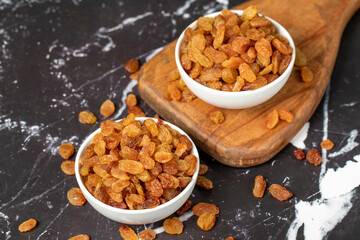 Raisins. Sun-dried grapes in ceramic bowl. superfood. Vegetarian food concept. healthy snacks