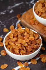 Raisins. Sun-dried grapes in ceramic bowl. superfood. Vegetarian food concept. healthy snacks. close up