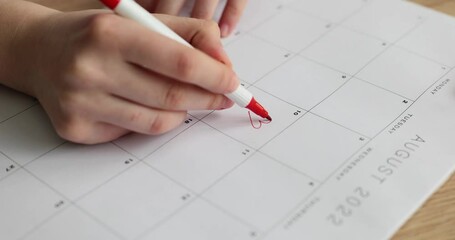 Person draws red heart on calendar on 10th. Wedding day dating and romantic concept or valentine day