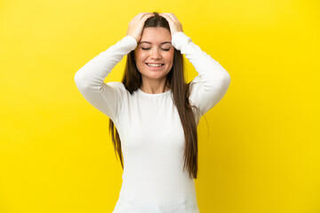 Young caucasian woman isolated on yellow background laughing