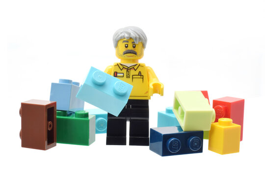 Lego minifigure toy  with old man face, colorful bricks isolated on white. Editorial illustrative image of popular plastic constructor.