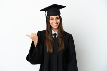 Young university graduate isolated on white background pointing to the side to present a product
