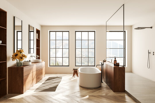 Cozy bathroom interior with bathtub, sink and douche with panoramic window