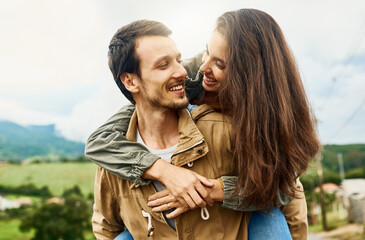 Date, love and piggyback with couple in nature for happy, smile and bonding. Happiness, relax and care with man carrying woman in countryside field for spring, anniversary vacation and travel