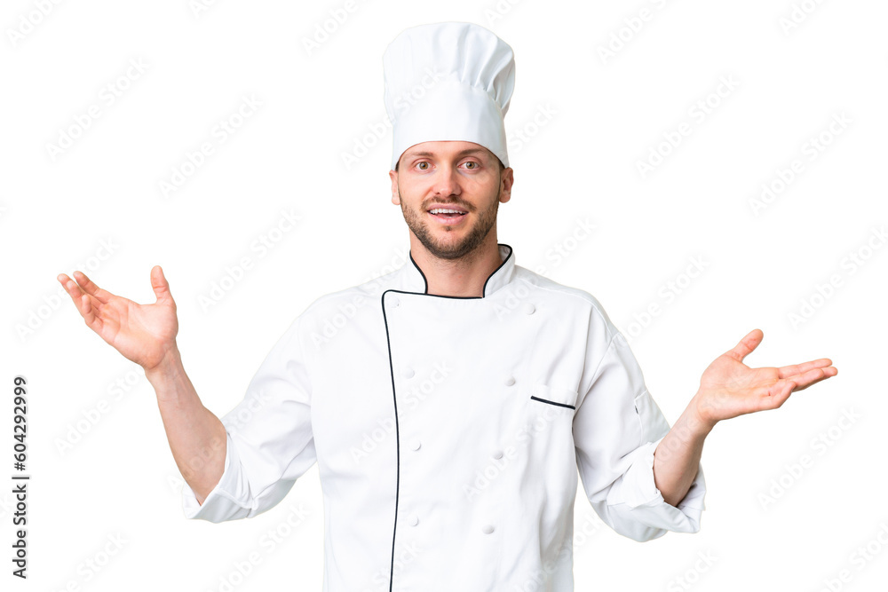 Wall mural Young caucasian chef over isolated chroma key background with shocked facial expression