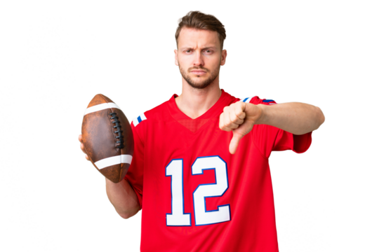 Young caucasian man playing rugby over isolated chroma key background showing thumb down with negative expression