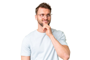 Young handsome caucasian man over isolated chroma key background With glasses and thinking while looking up