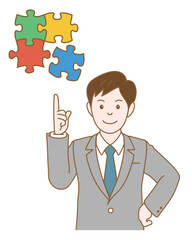 パズルのピースを指差すビジネスマン