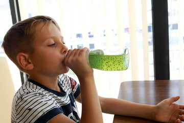 Boy drinking lemonade from bottle