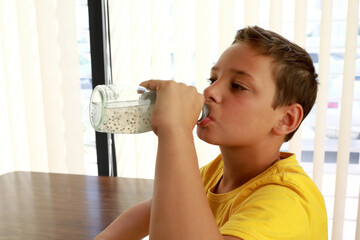 Child drinking lemonade from bottle