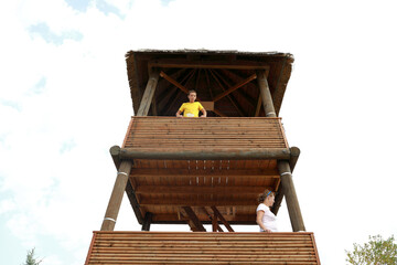 Mother with son on observation wooden tower