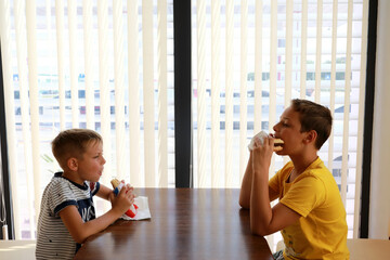 Two brothers eating fast food