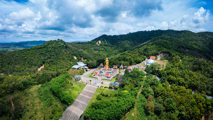 Fototapeta na wymiar Aerial drone Of the beautiful Buddha statue on the hill (on top of mountain). At Hatyai, Songkhla, Thailand. The attitude of persuading the relatives not to quarrel.