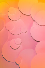 Colorful abstract pattern with circles in gradient light of pink and yellow color with shadows, top view. Abstract background in fantasy hipster young style, vertical.