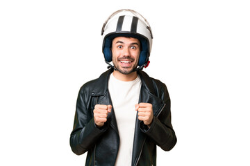 Young caucasian man with a motorcycle helmet over isolated chroma key background celebrating a victory in winner position