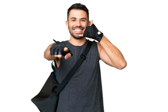 Young sport caucasian man with sport bag over over isolated chroma key background making phone gesture and pointing front