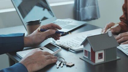 Real estate agent and realtor general liability insurance businessman professional consultant with house toy model - Powered by Adobe