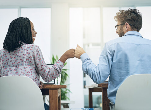 Back, teamwork and fist bump celebration with business people in their office, working together on a company project. Motivation, collaboration and friends or colleagues celebrating their success