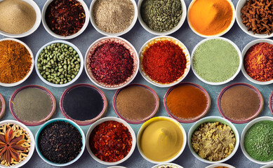 Variety of spices and herbs in bowls over grey background, top view. Generated AI