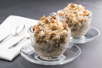 wheat and milk porridge with sugar cooked, Arabian sweet of Wheat pudding topped with walnuts 