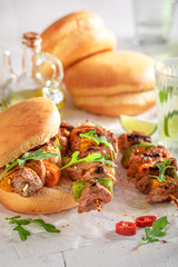 Hot roasted shashlik with bun baked on a grilled.