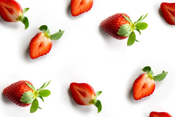 Strawberries on a white background. Pattern of whole berries and halves in random order. Composition in the style of flat lay.