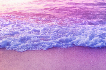 Tender dreamy pink sea waves on shore. Filtered color. - 604304926