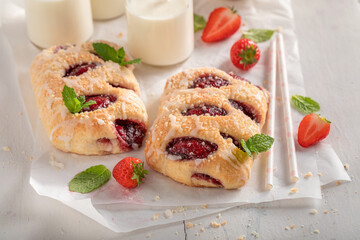 Yummy strawberry yeast cake served with milk.