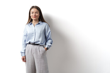Young caucasian woman, professional entrepreneur standing in office clothing, smiling and looking...