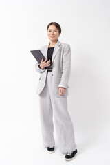 Young caucasian businesswoman formal wear, holding digital tablet, standing over white background....